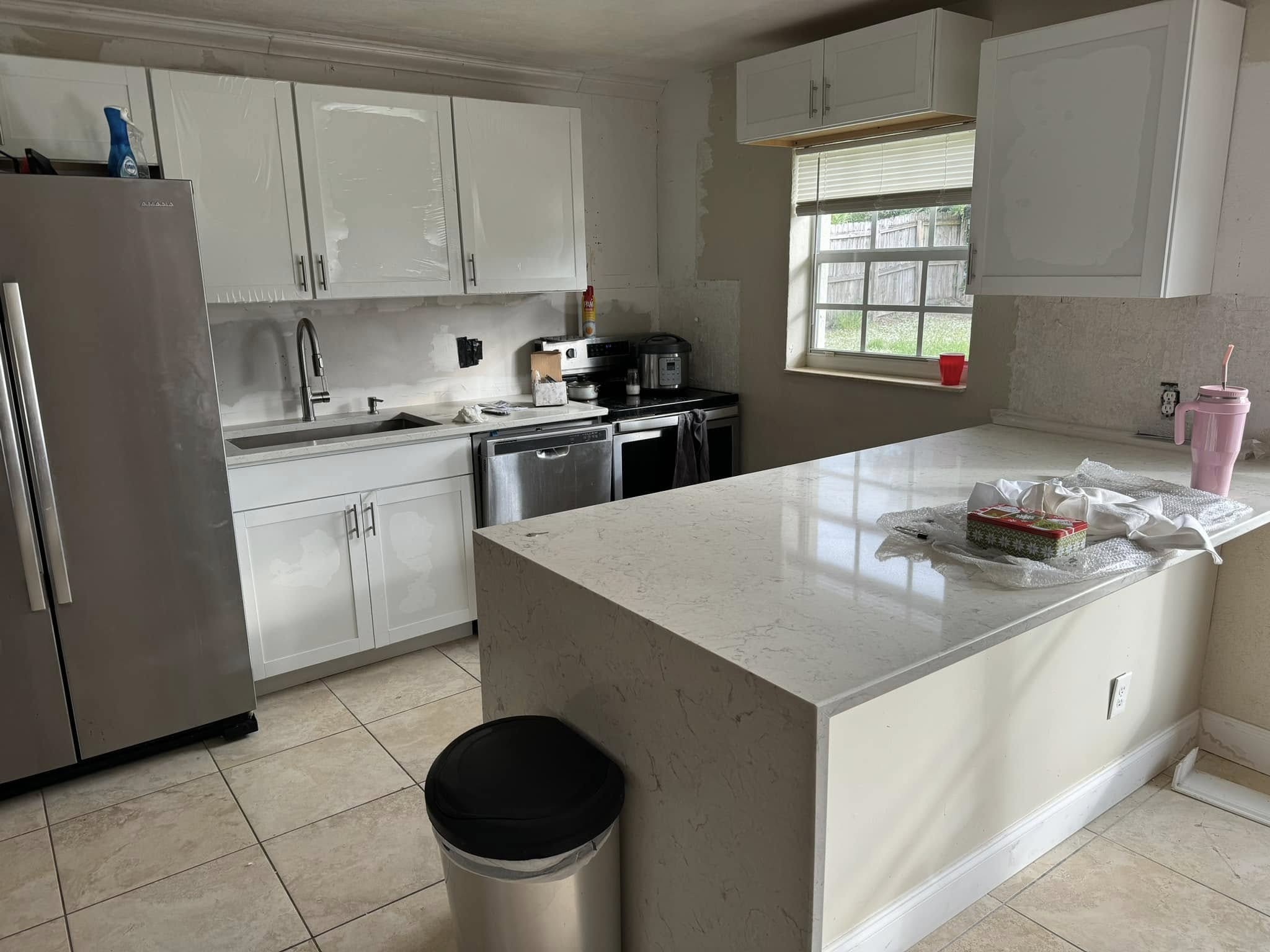 White kitchen cabinets with quartz countertops, kitchen remodel in Port St. Lucie, FL by Dependable Guys LLC
