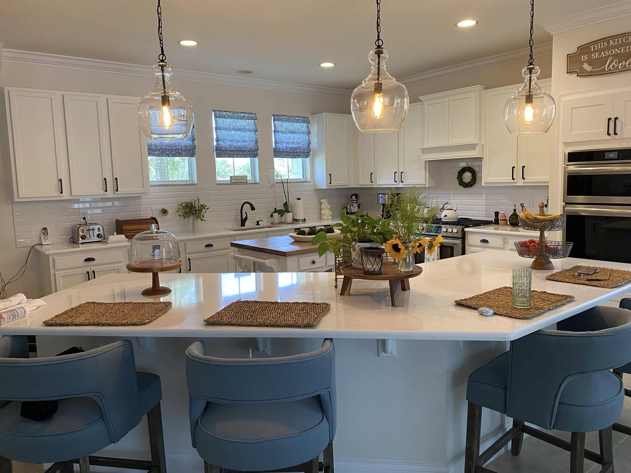 Finished kitchen remodel in Port St. Lucie, FL with large island, pendant lighting, and custom seating by Dependable Guys LLC